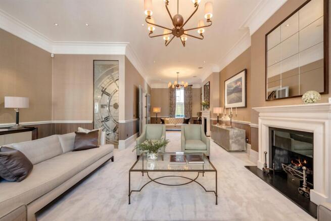 Double reception room with marble floor and fireplace