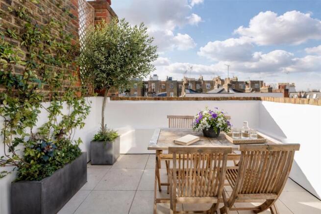 West-facing roof terrace with rooftop views and olive tree