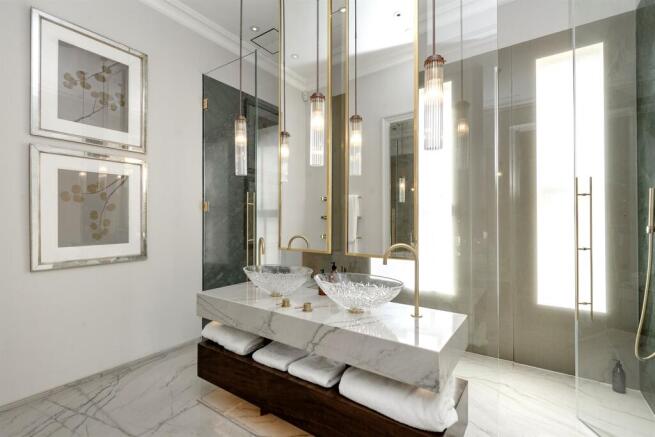 Principal bathroom with twin glass basins and walk-in shower