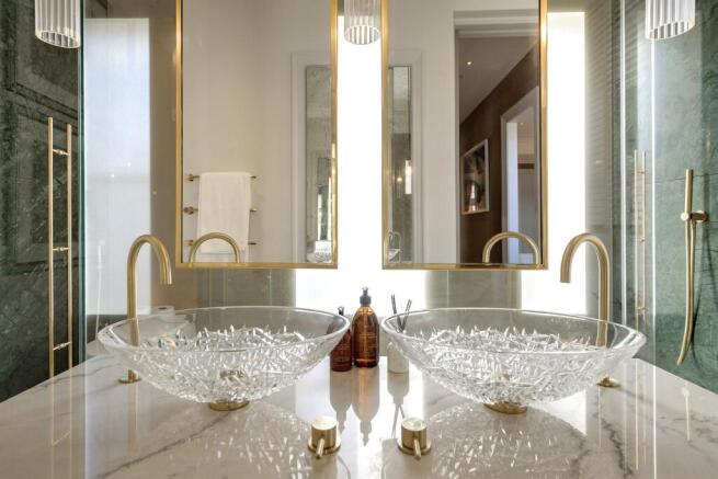 Bathroom detail with crystal twin basins and green marble
