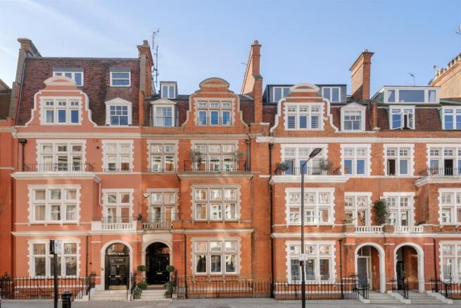 Red-brick and stucco mansion facade at Palace Court, Bayswater